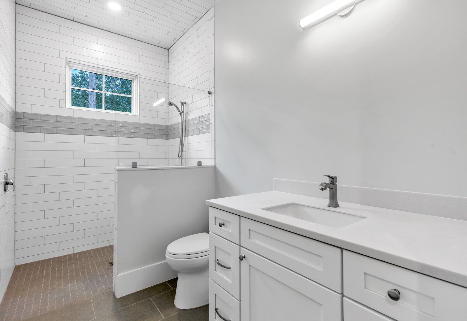 A bathroom with a toilet , sink , and shower.