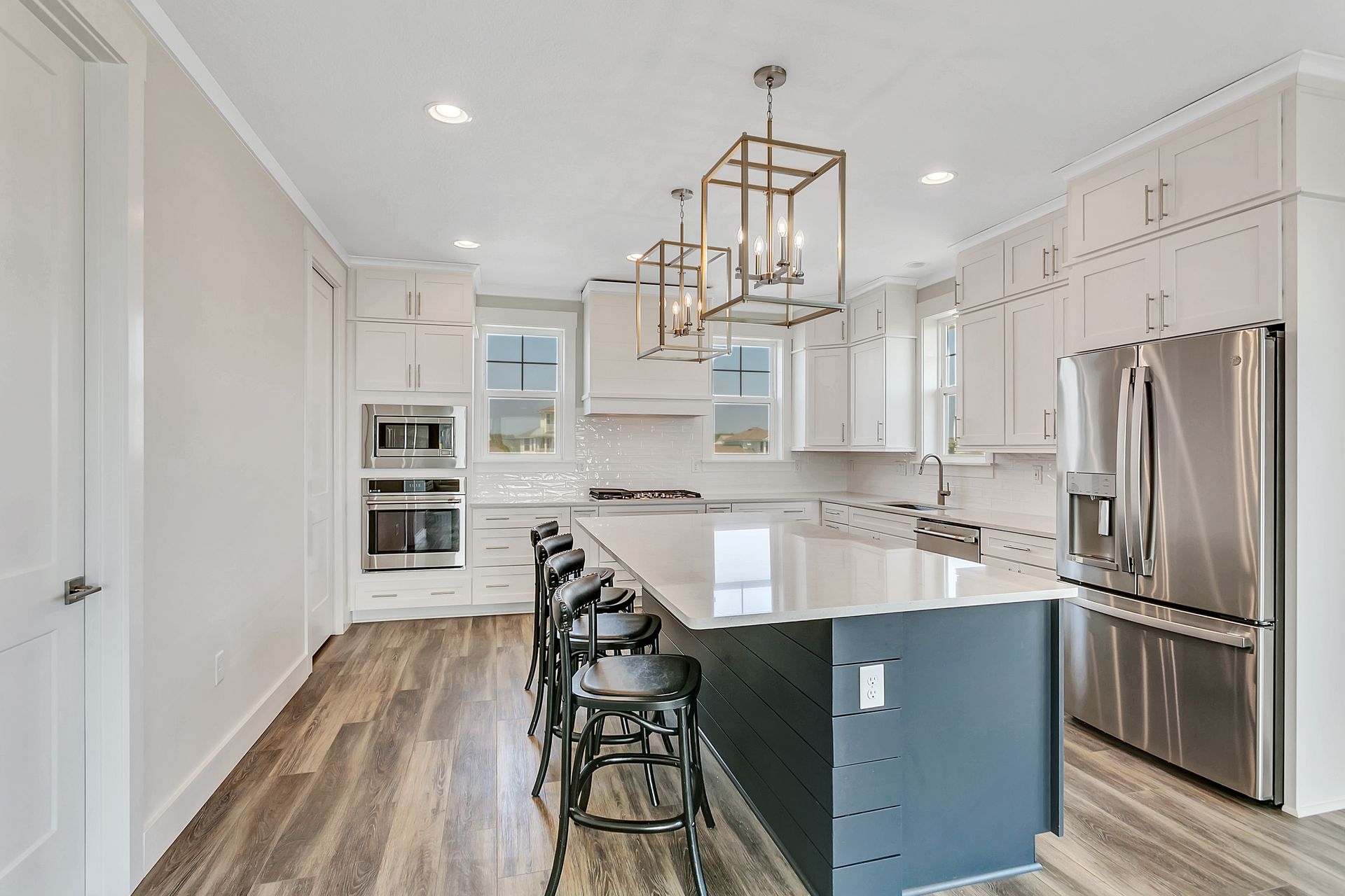 A kitchen with stainless steel appliances and a large island.