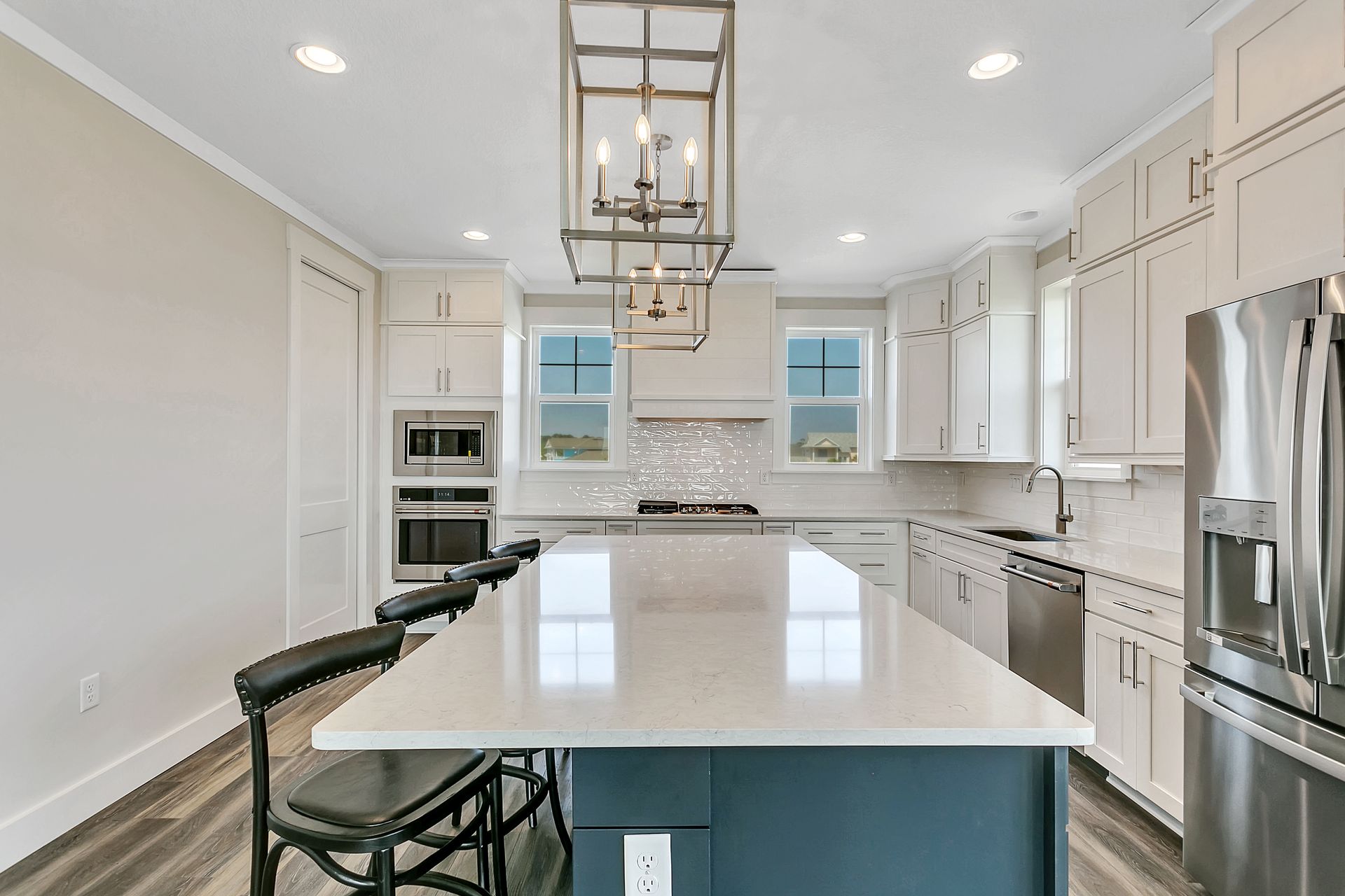 A kitchen with a large island and stainless steel appliances.