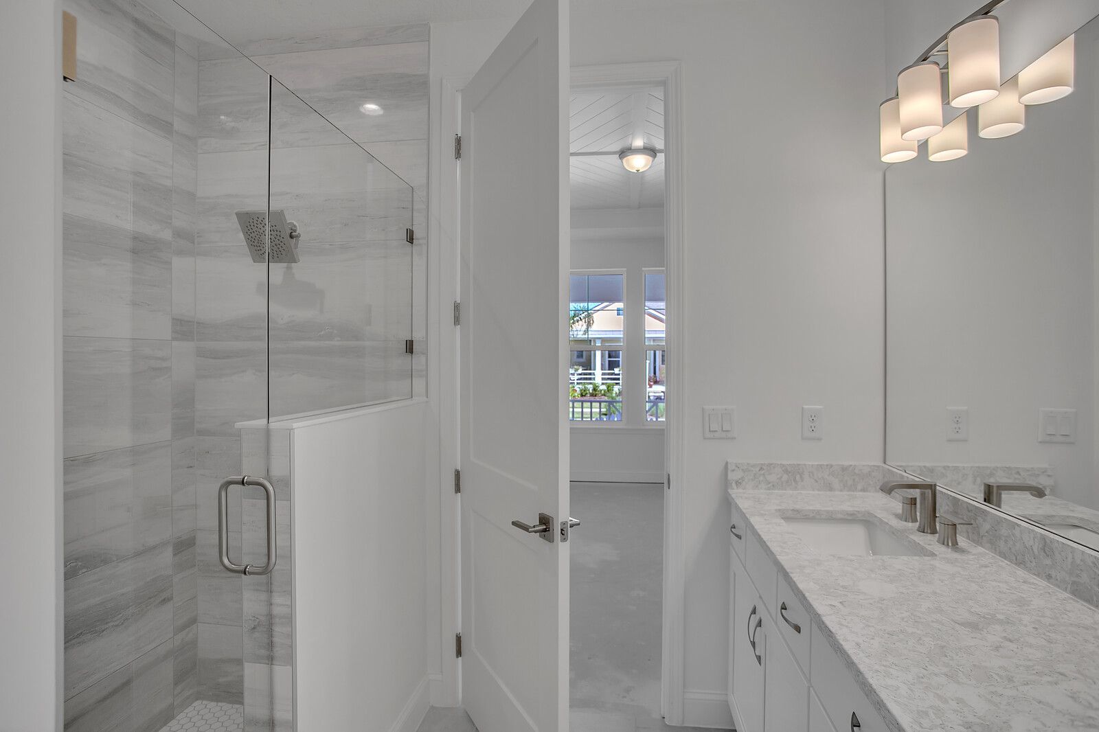 A bathroom with two sinks and a walk in shower