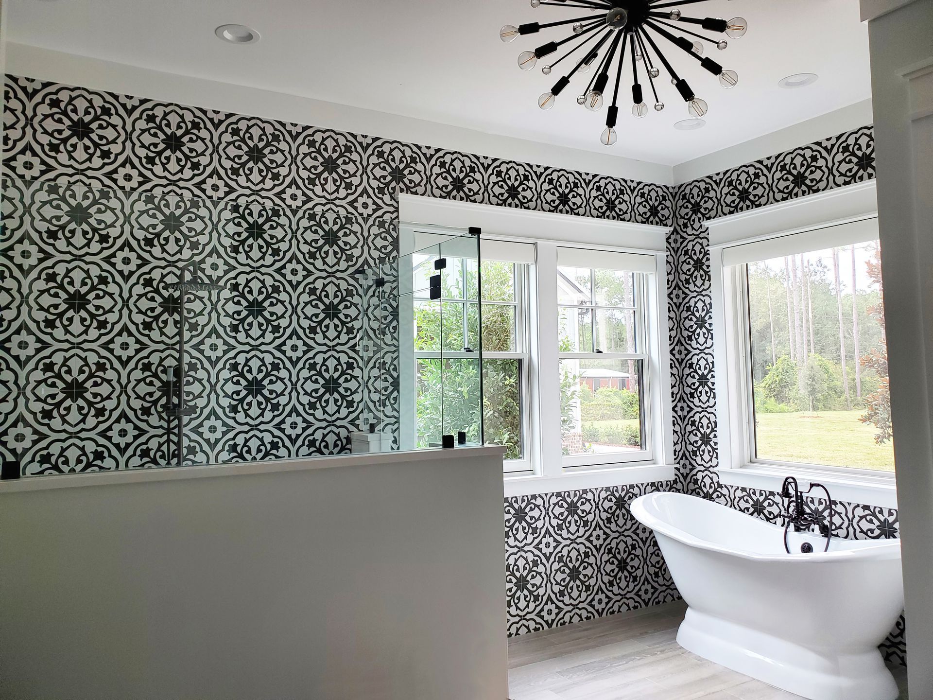 A bathroom with a bathtub , shower , and window.