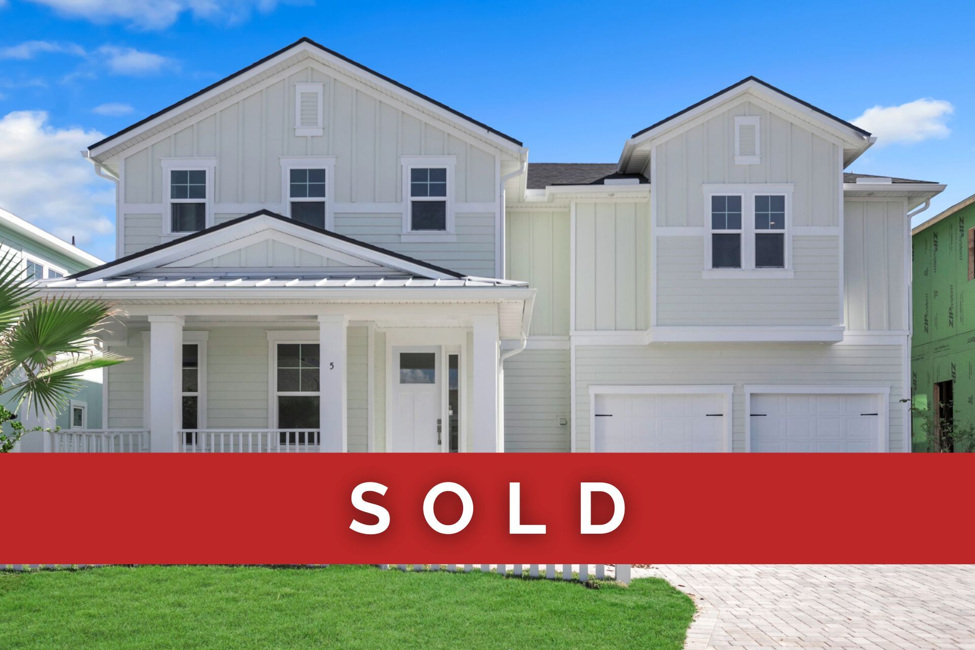 A white house with a white picket fence in front of it