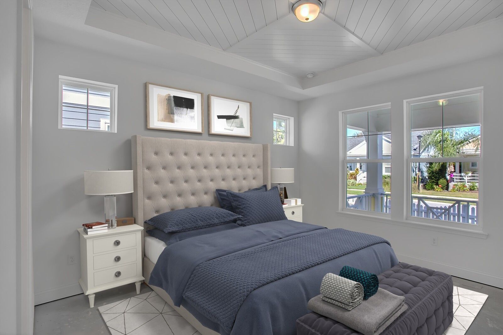 A bedroom with a bed , nightstands , lamps and windows.