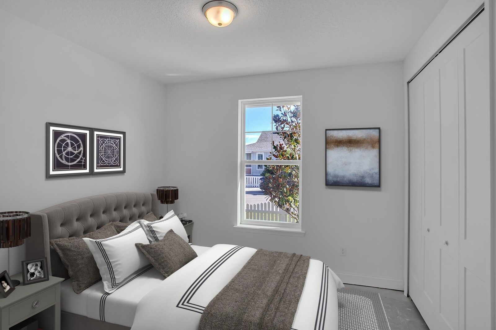 A bedroom with a large bed and a window.