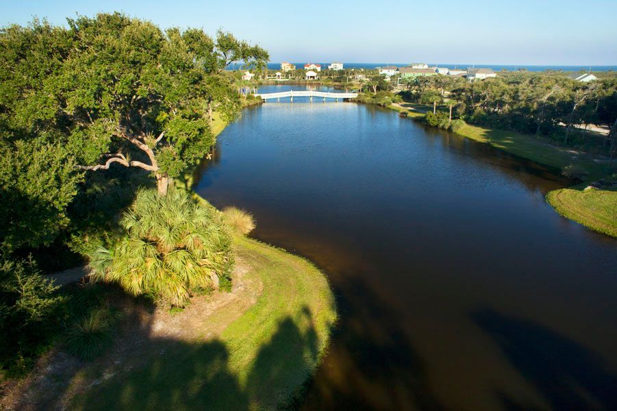 An aerial view of a large body of water surrounded by trees.