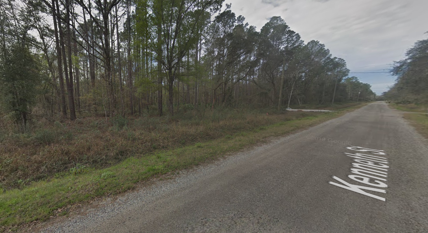 A road with a lot of trees on the side of it.