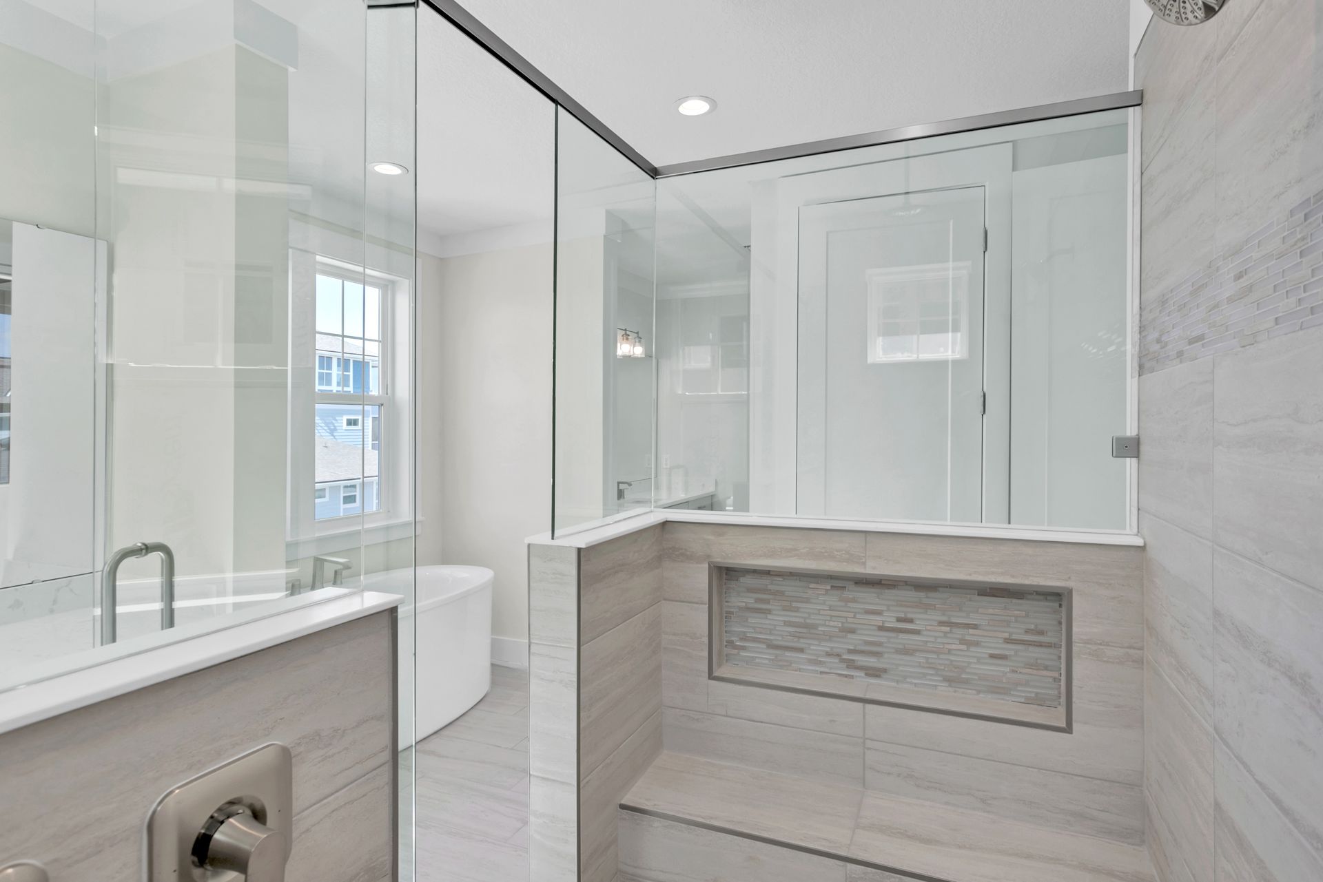 A bathroom with a walk in shower and a bathtub.