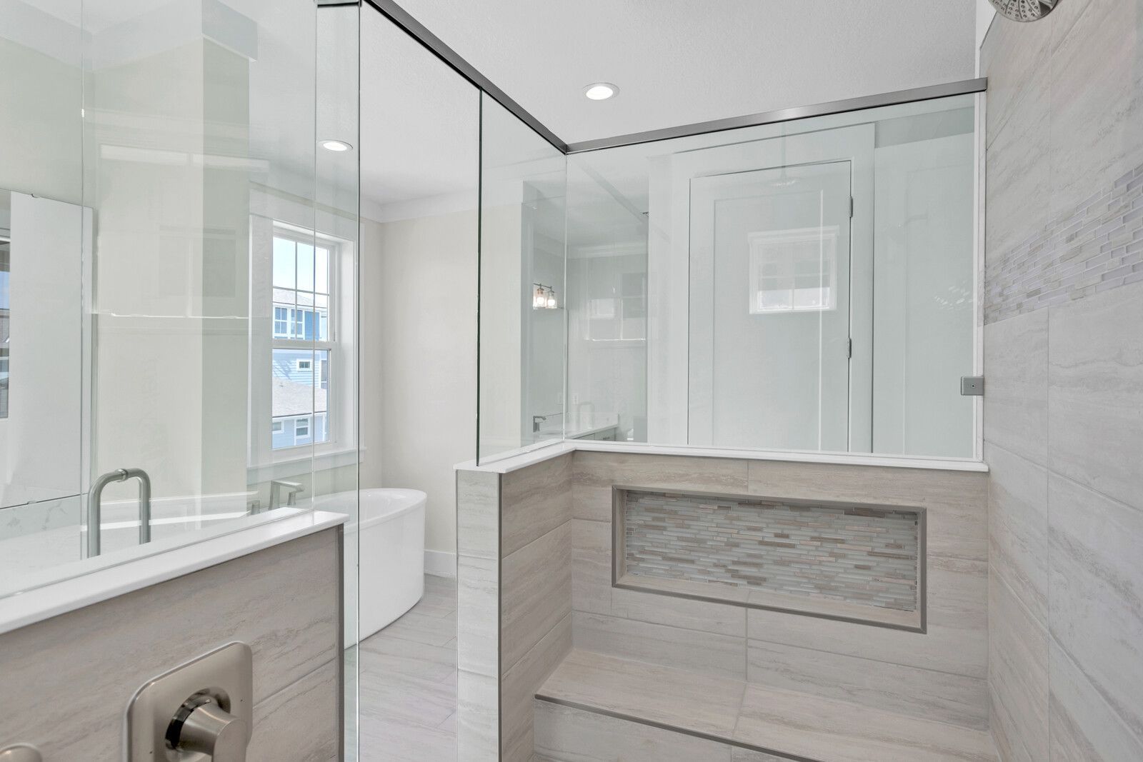 A bathroom with a walk in shower and a bathtub.