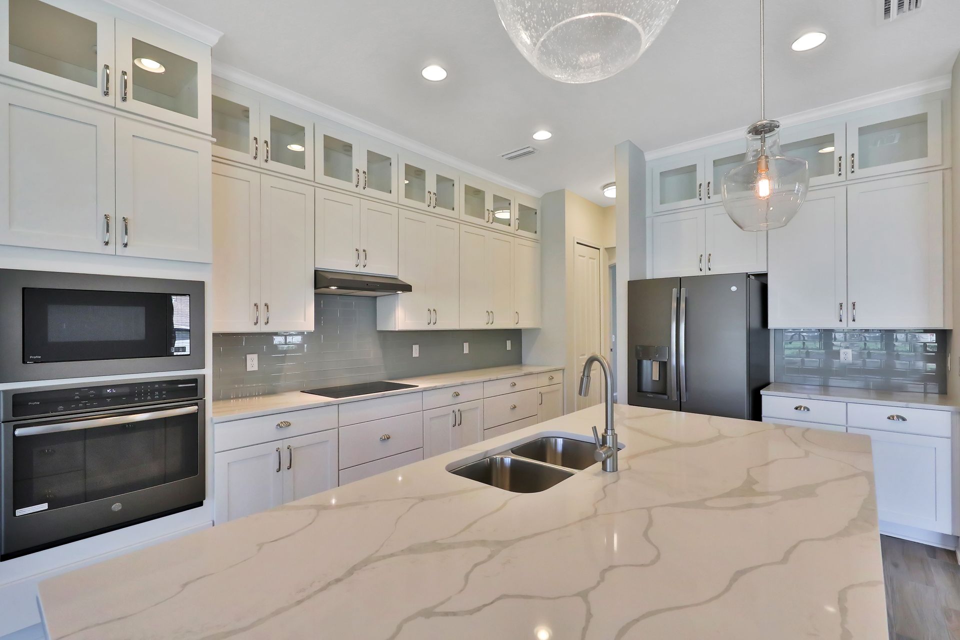 A kitchen with white cabinets and stainless steel appliances
