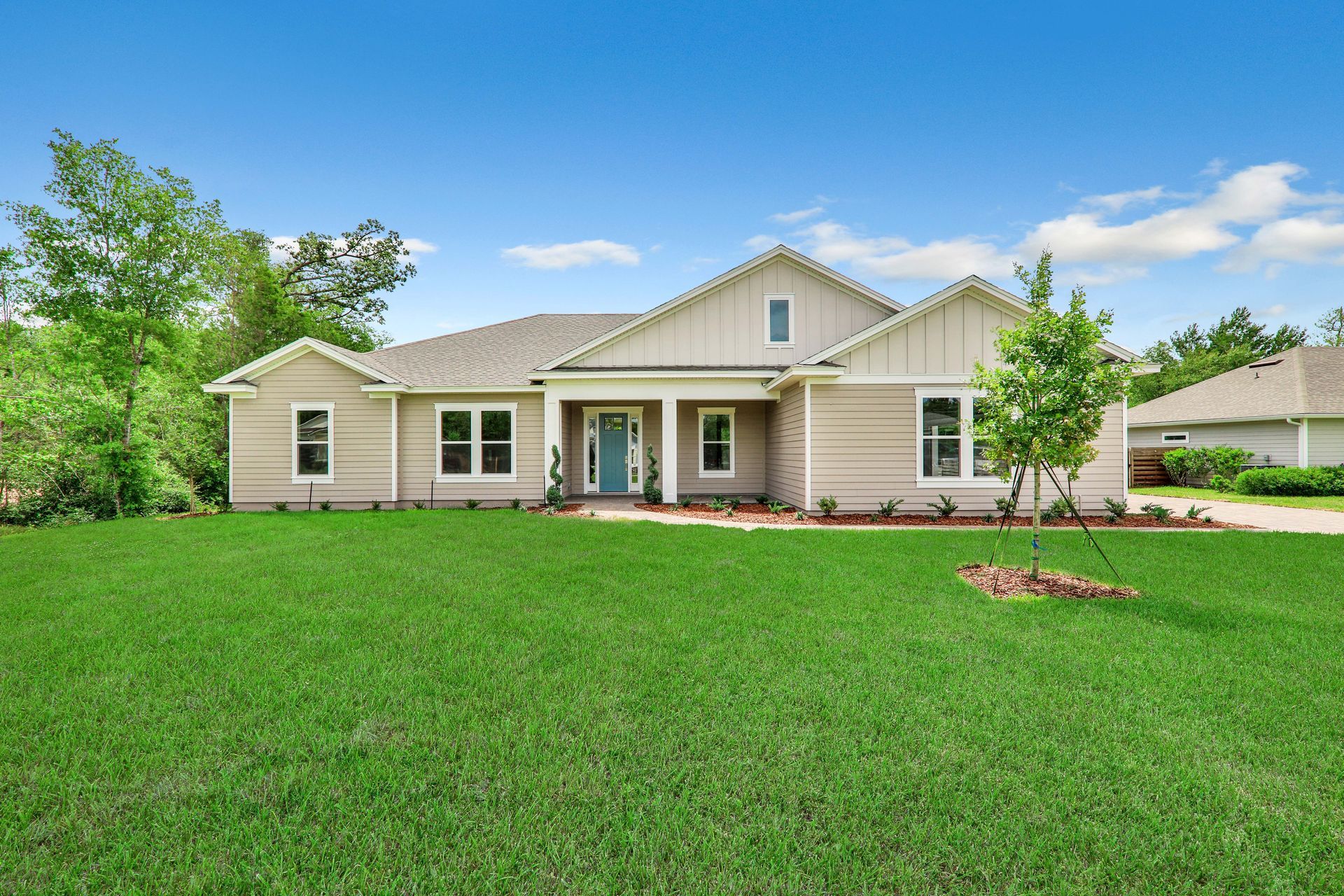 A large house with a lush green lawn in front of it.
