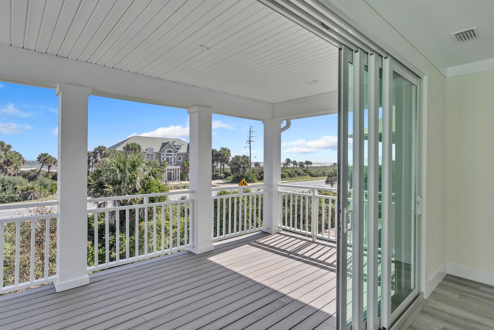 A balcony with a sliding glass door and a railing.