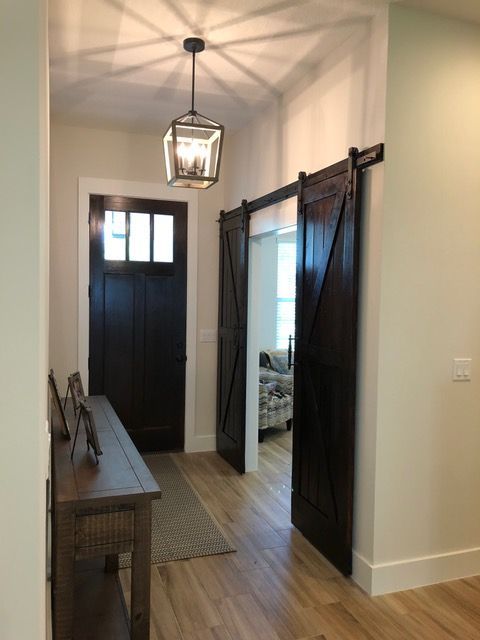 A hallway with sliding barn doors and a table