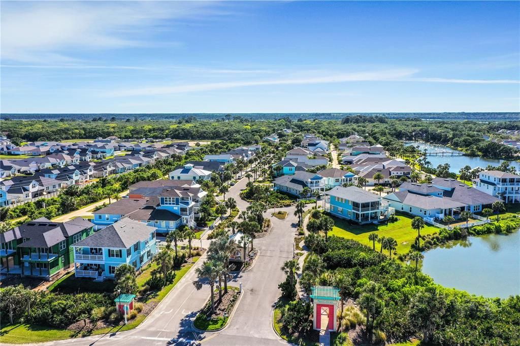 An aerial view of a residential area with a lake in the middle of it.