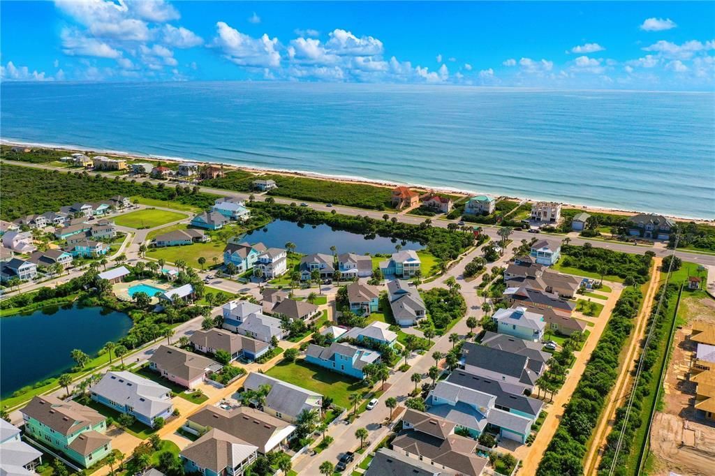 An aerial view of a residential area next to the ocean.