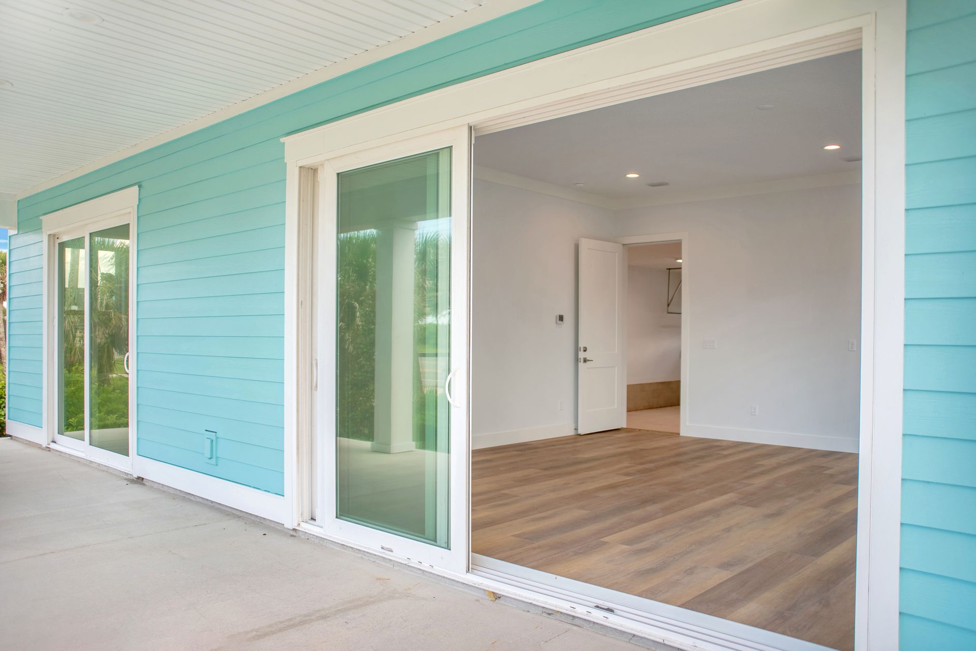 A house with blue siding and sliding glass doors