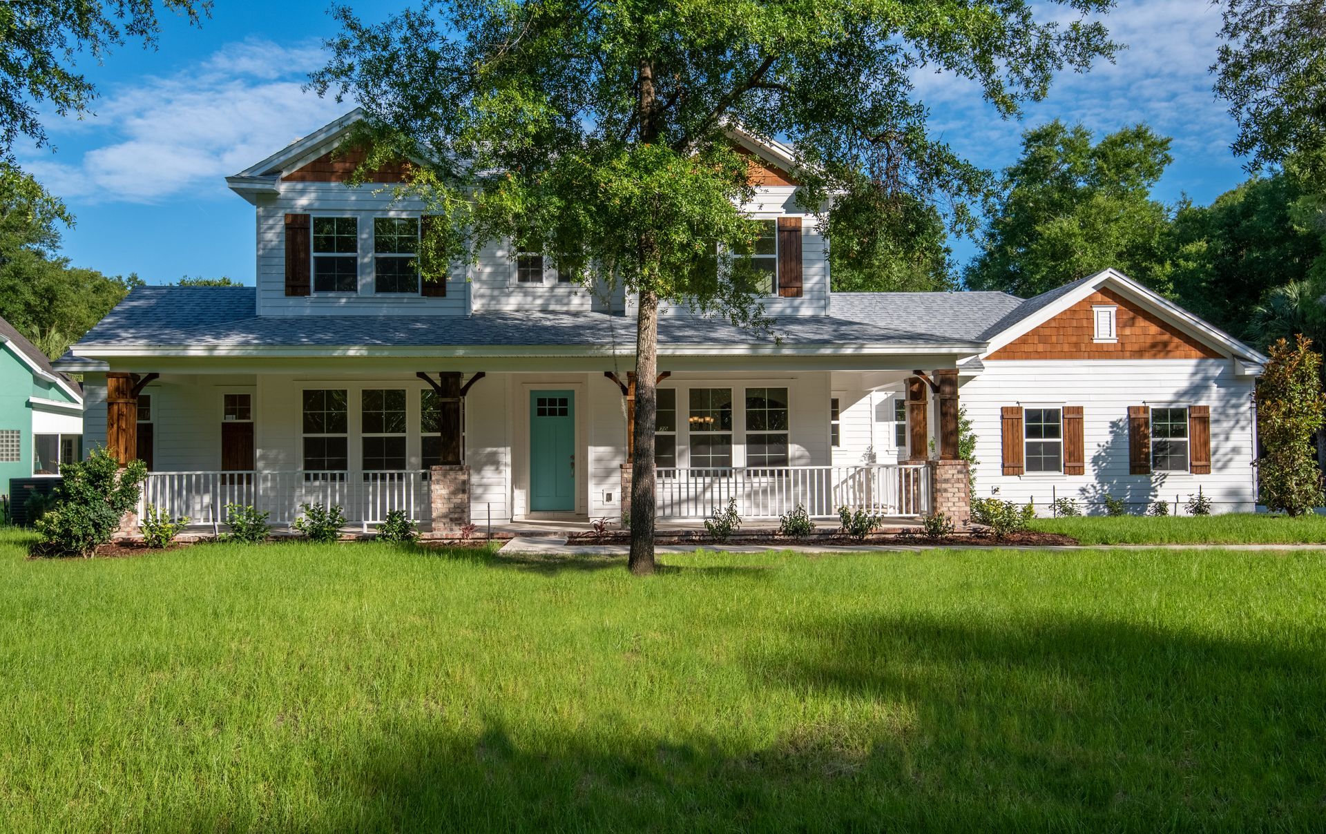 A large white house with a large lawn in front of it.