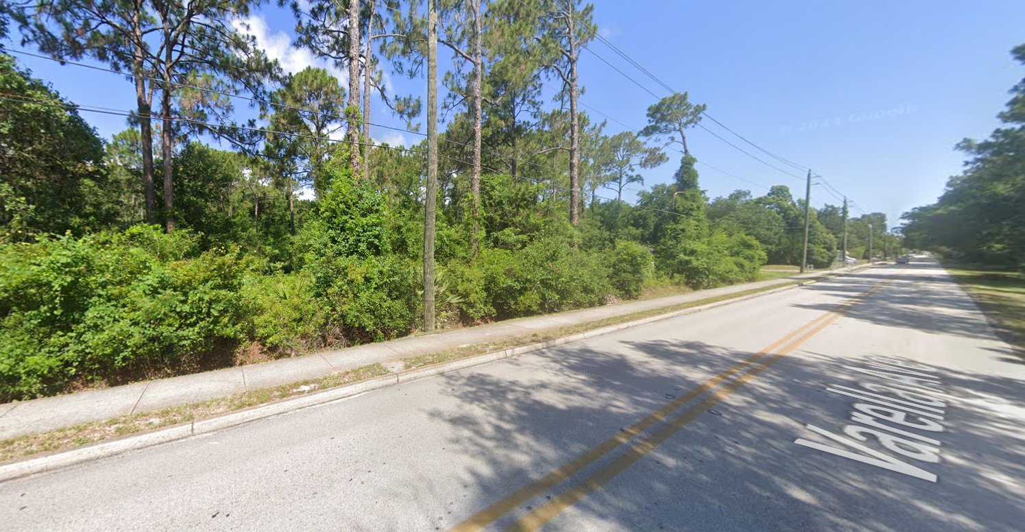 A road with a lot of trees on the side of it