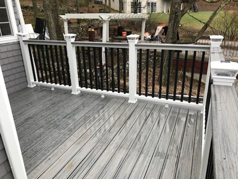 Gray composite deck with white railings and black balusters. 