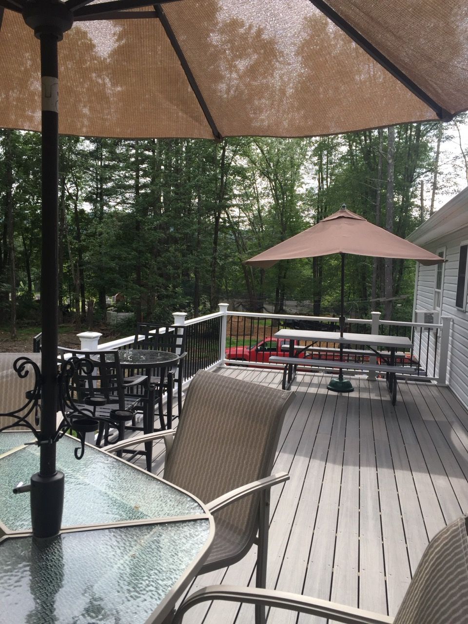 Deck with umbrellas, tables, and chairs.