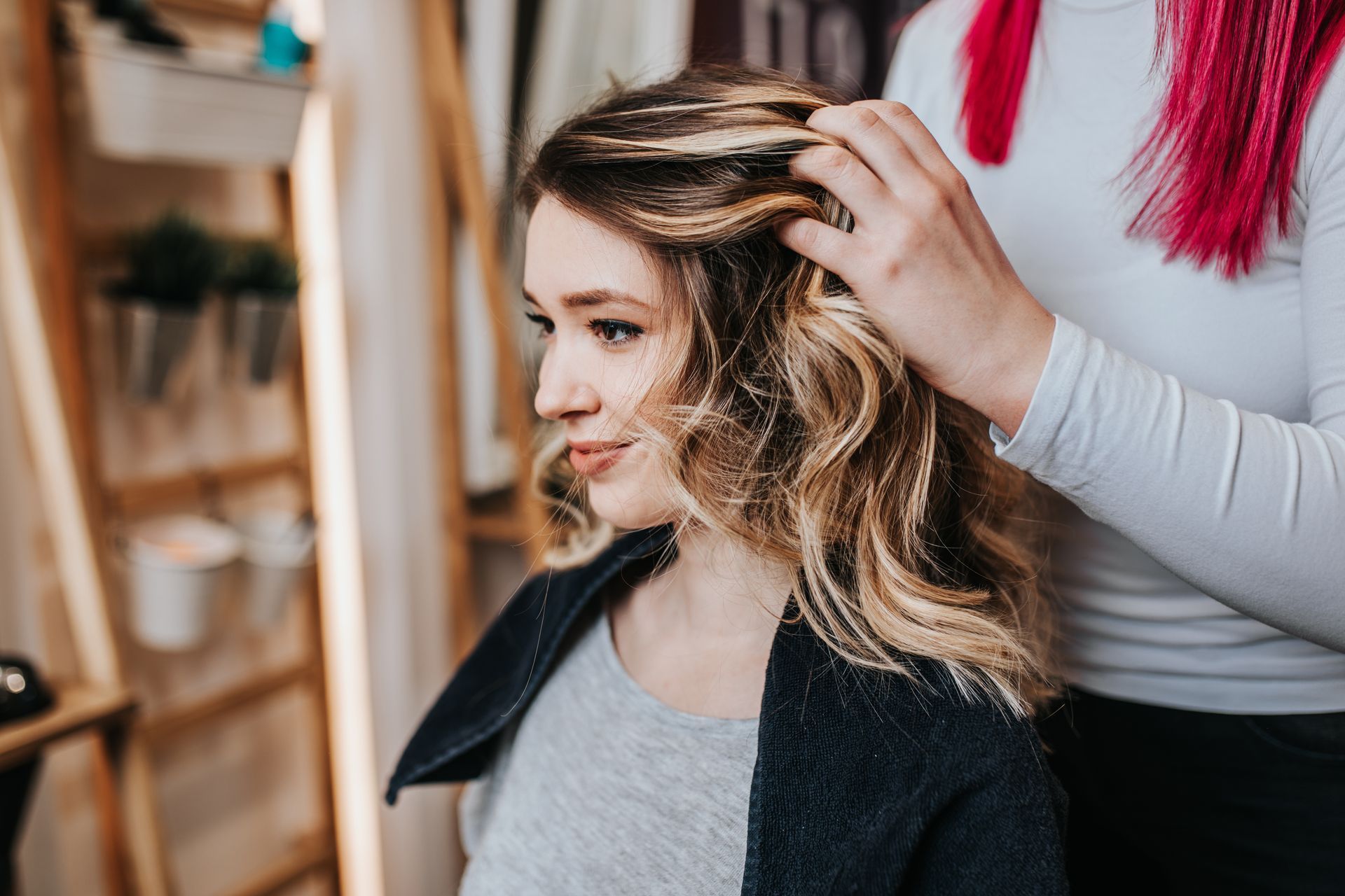 Woman with wavy blonde hair at a salon