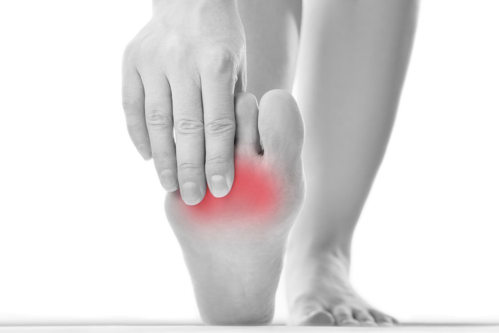 A Person Is Holding Their Foot In Pain — Sandy Gugenberger Podiatrist in Port Macquarie, NSW