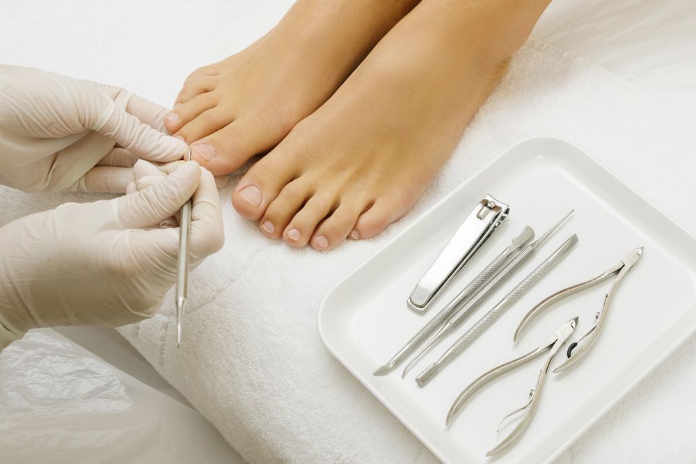 A Person Is Getting Their Toenails Cut By A Nail Clipper — Sandy Gugenberger Podiatrist in Port Macquarie, NSW