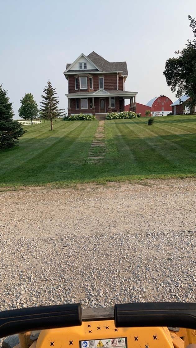 A yellow atv is parked in front of a house