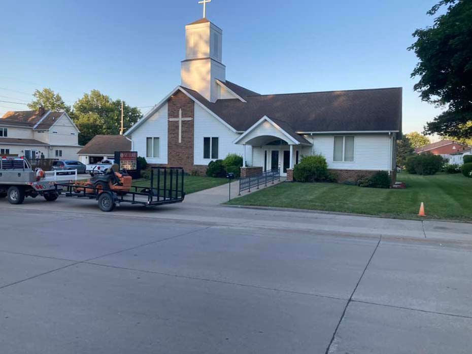 A church with a trailer parked in front of it