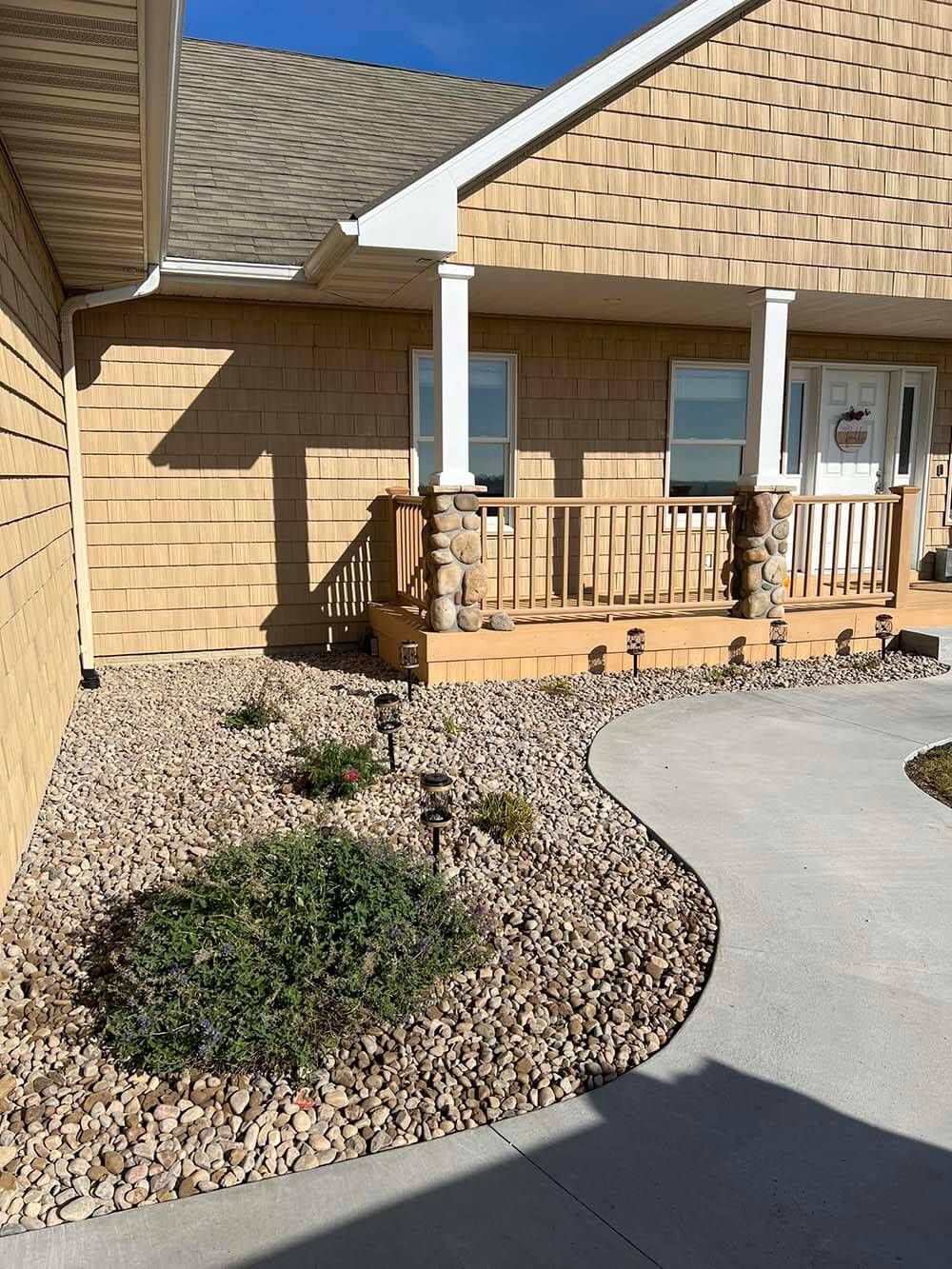 A house with a porch and a walkway leading to it.