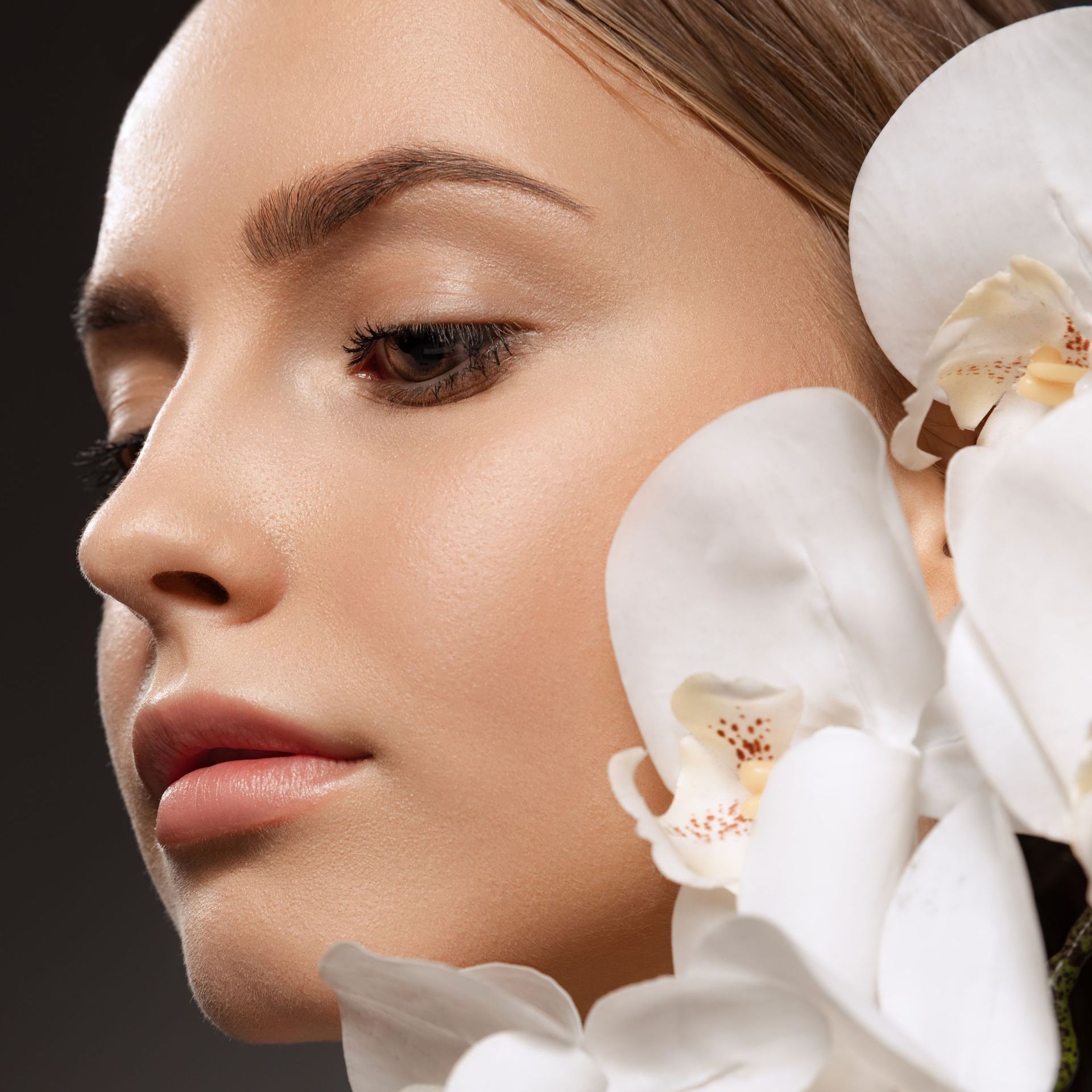 Woman 's face with white flowers at Lush Aesthetics Med Spa
