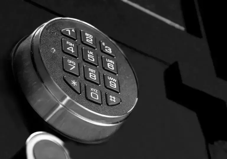 A black and white photo of a keypad on a safe.