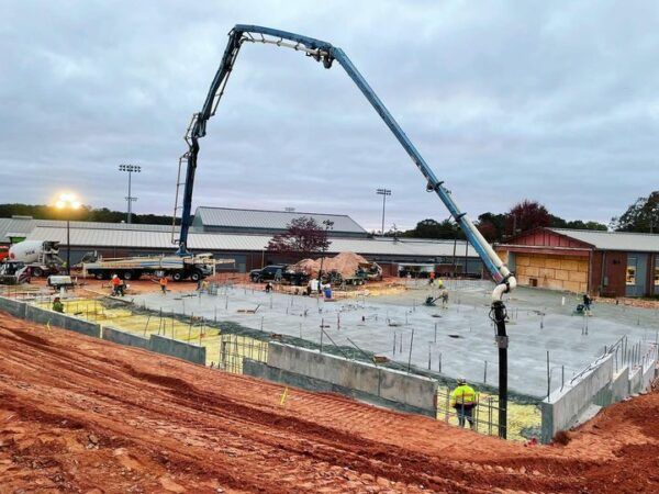 A concrete pump is being used to pour concrete on a construction site.