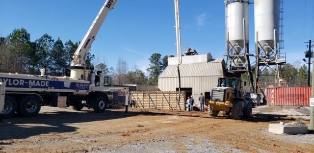 A crane is being used to pump concrete into a concrete plant.