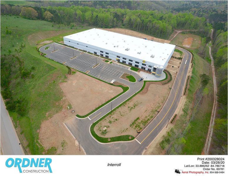 An aerial view of a large white building with ordner construction written on the bottom