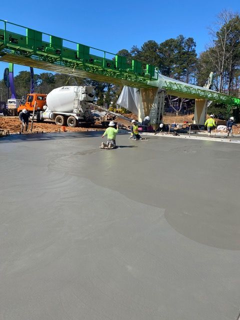 A concrete truck is pouring concrete on a construction site