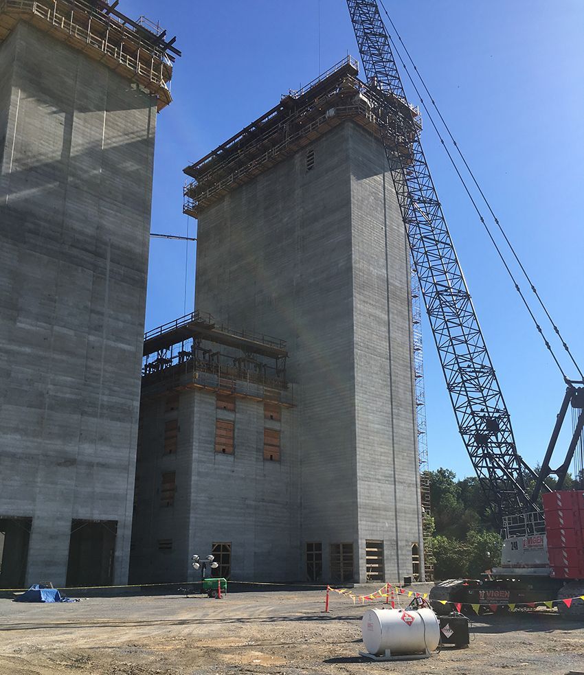 A large building under construction with a large crane in the background