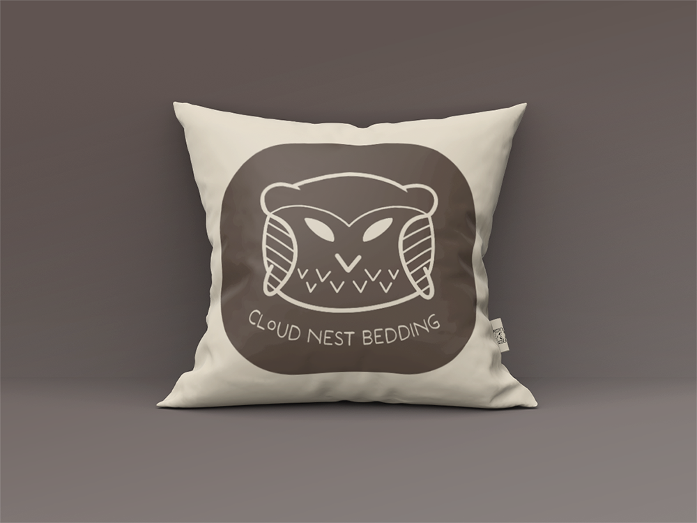 Cream pillow with a brown owl logo for 