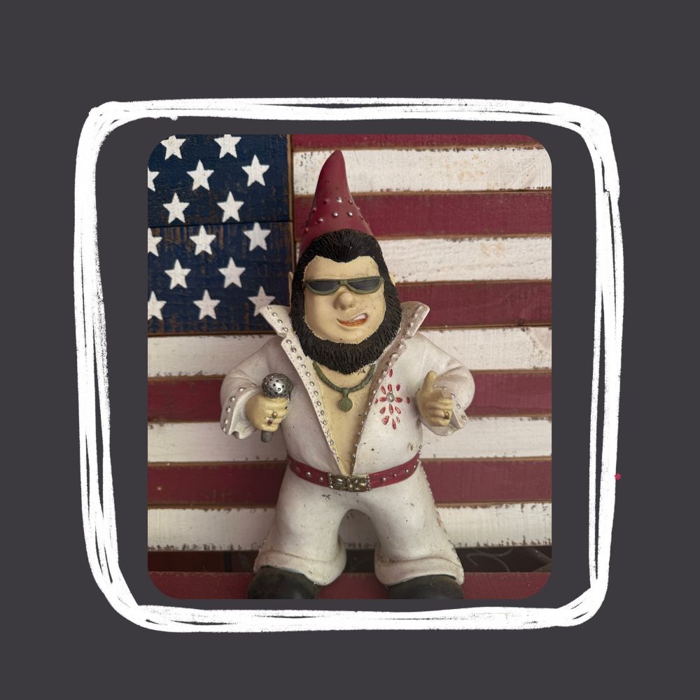Elvis Garden Gnome in front of the American flag.
