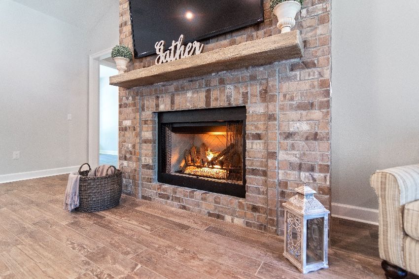 A living room with a fireplace and a flat screen tv.