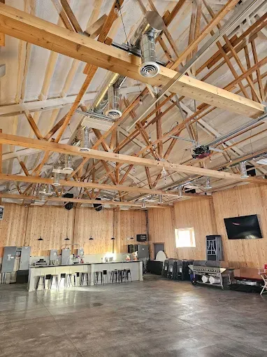 A large room with a wooden ceiling and a wooden floor.