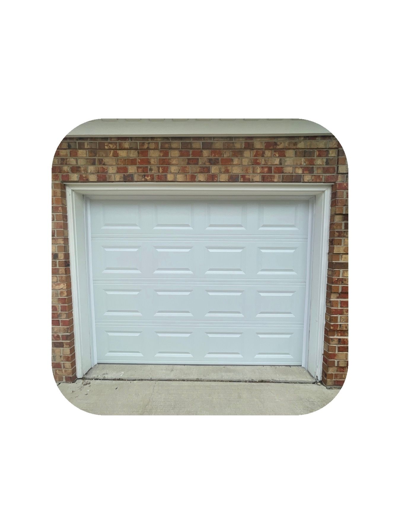White garage door set in a brick frame.