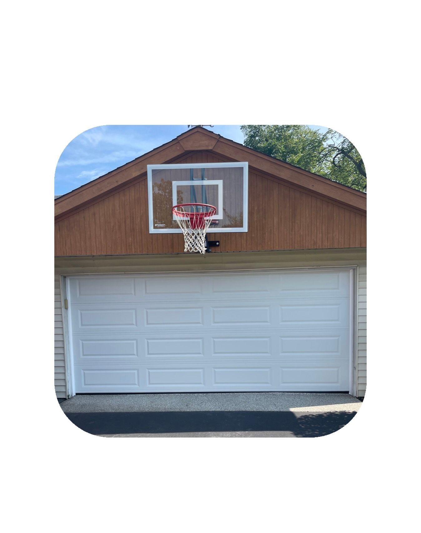 White garage door with a basketball hoop mounted above it.