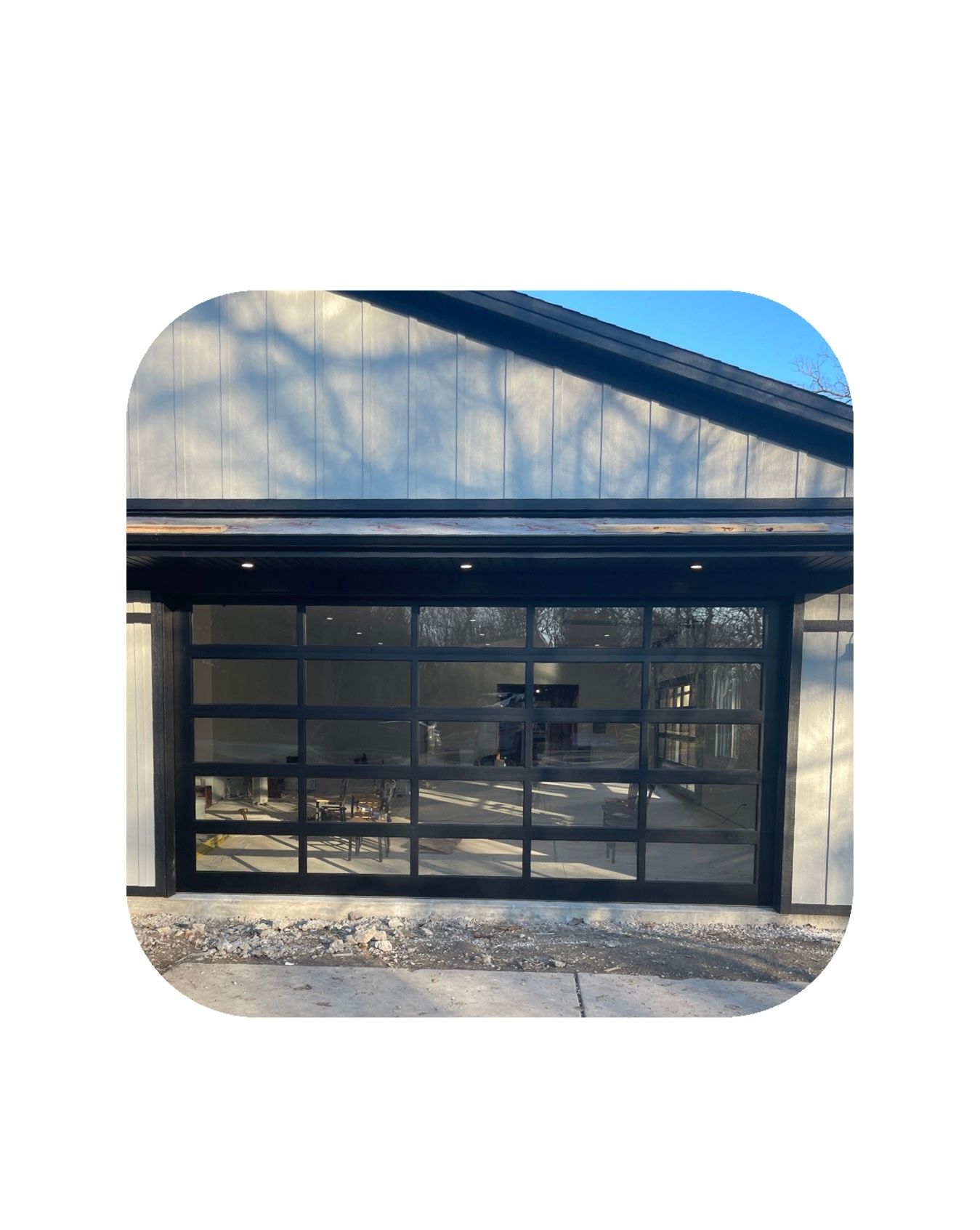 Modern garage door with glass panels and black frame.