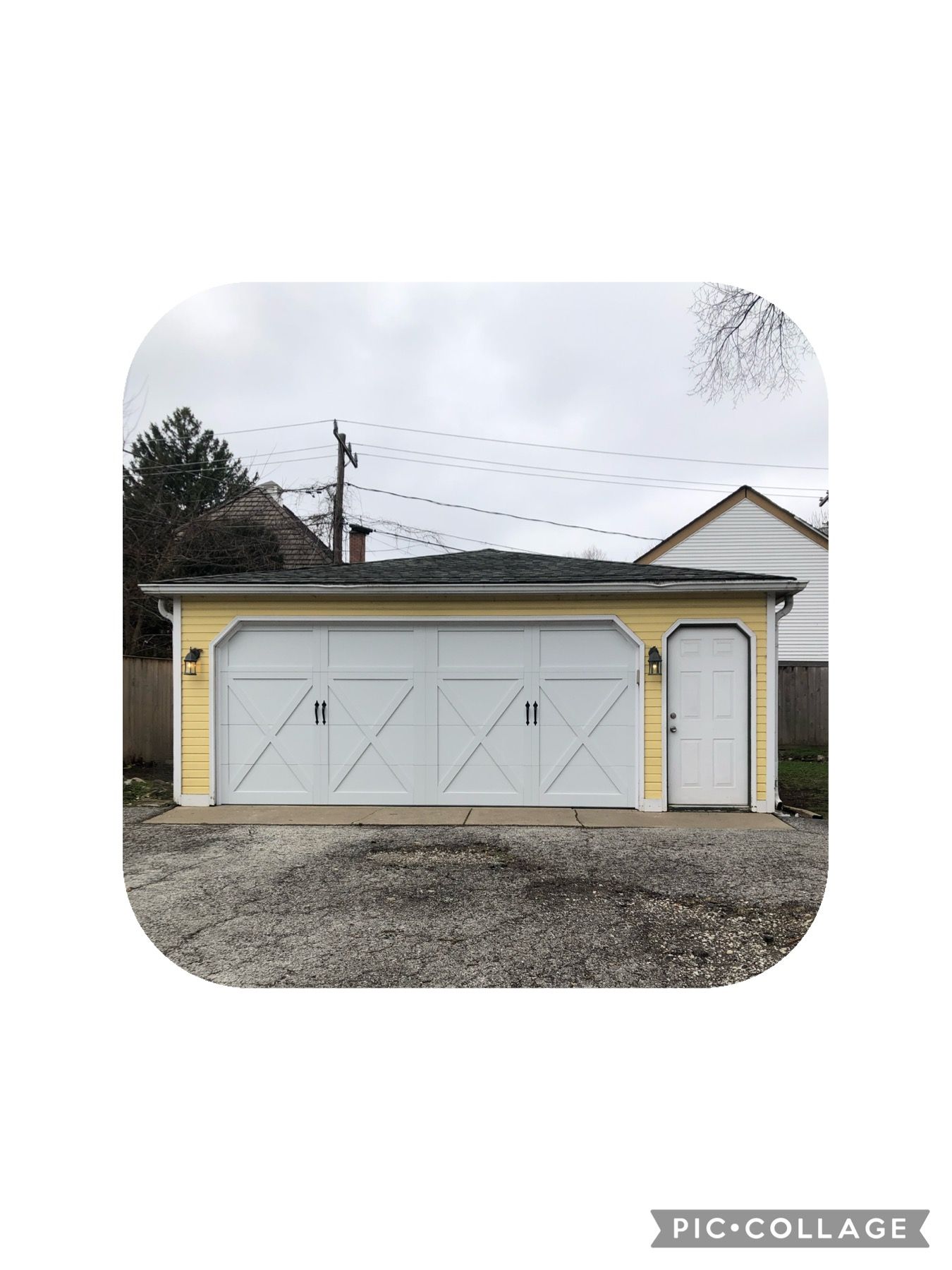 Yellow garage with white doors and a side door, gray gravel driveway, under a cloudy sky.