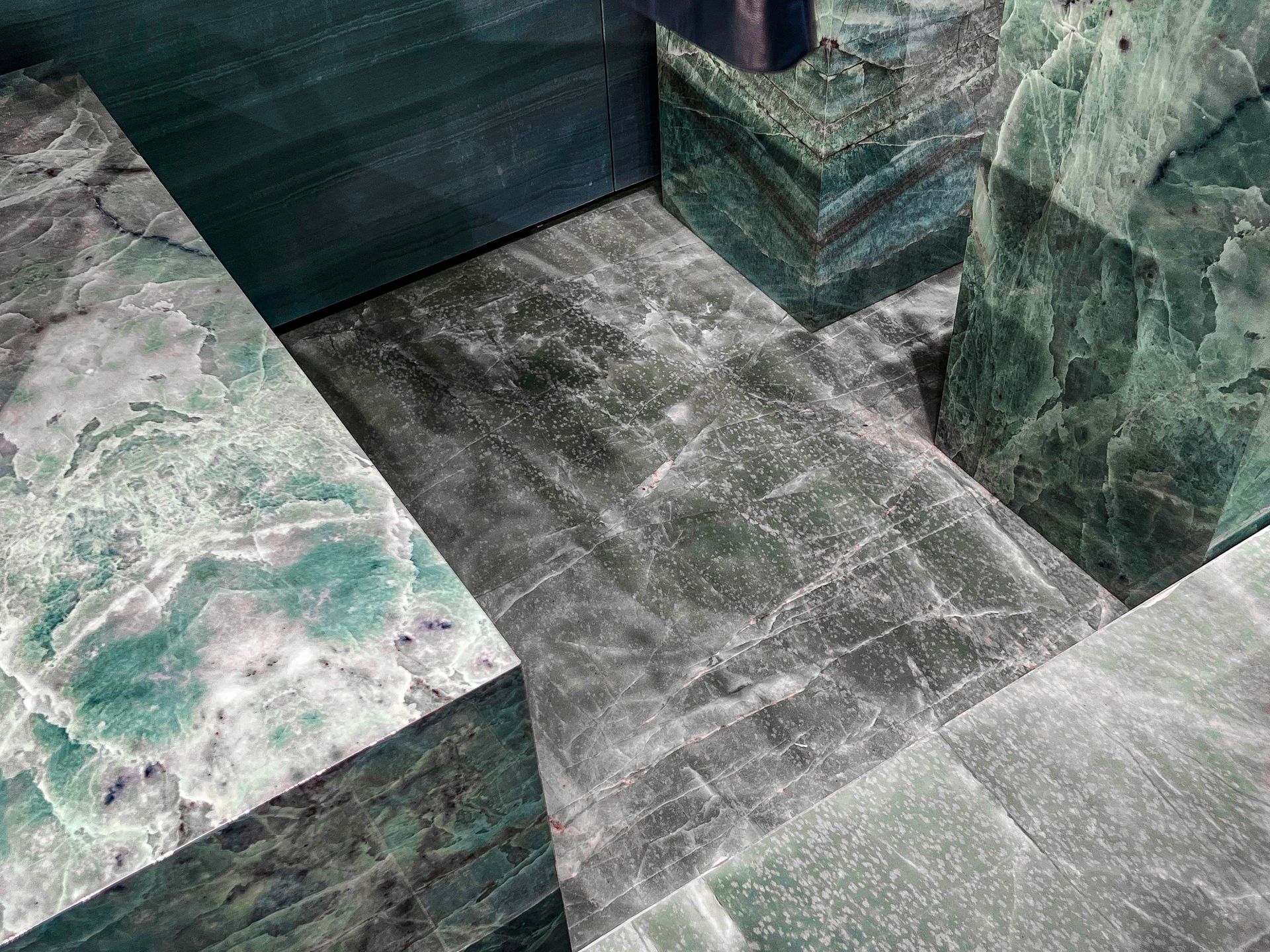 A close up of a green and white marble floor