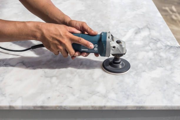 Close-up of man polishing marble.