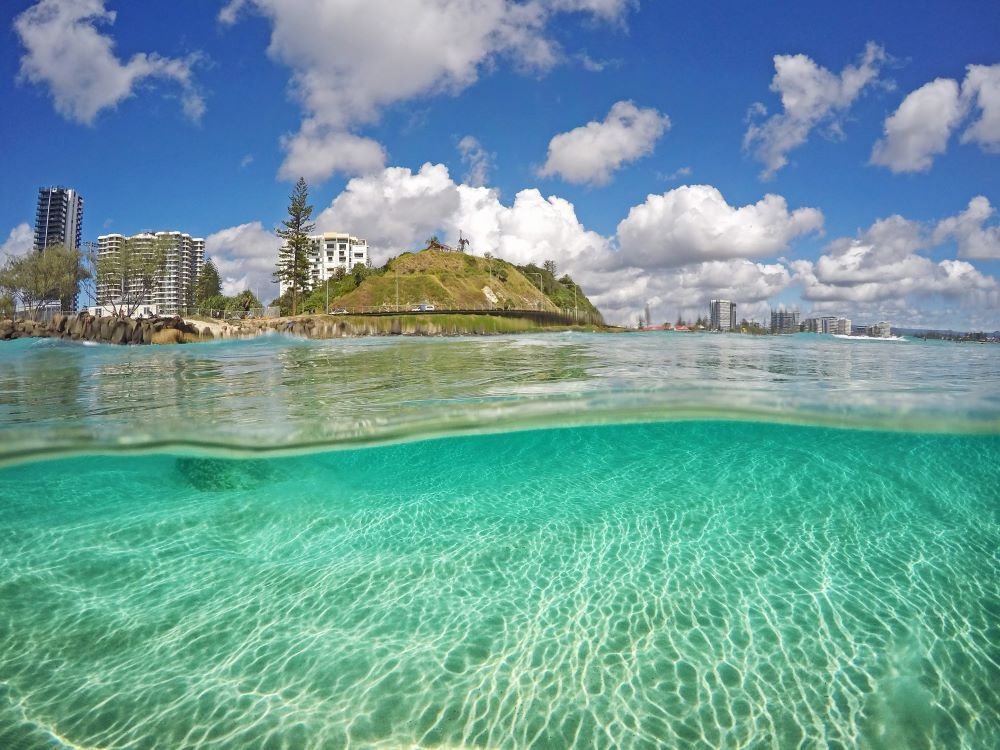 A Half Underwater View of a Beach With a City in the Background — NDR Trade Solutions in Coolangatta, QLD