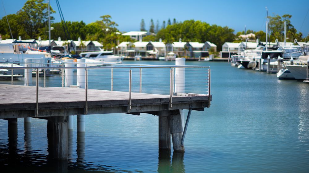 A Dock in a Marina With Boats Docked in the Background — NDR Trade Solutions in Hope Island, QLD