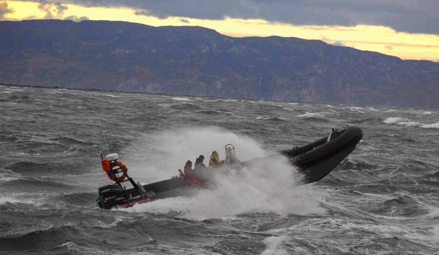 A group of people are riding a boat in the ocean.