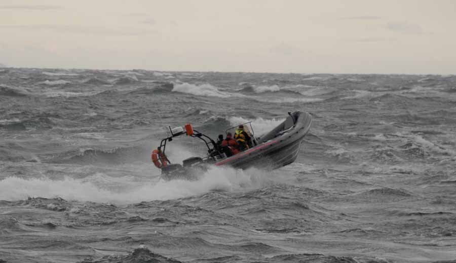 A boat is floating on top of a large body of water.